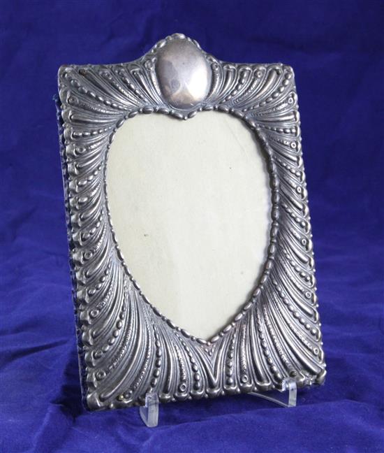 A late Victorian repousse silver photograph frame by William Comyns, 7.25in.